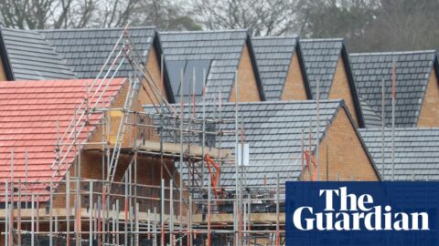 Homes under construction surrounded by scaffolding